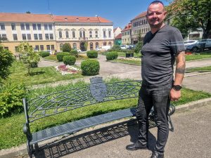 Szilveszter Szabolcs alpolgármester és a tíz címeres pad egyike
